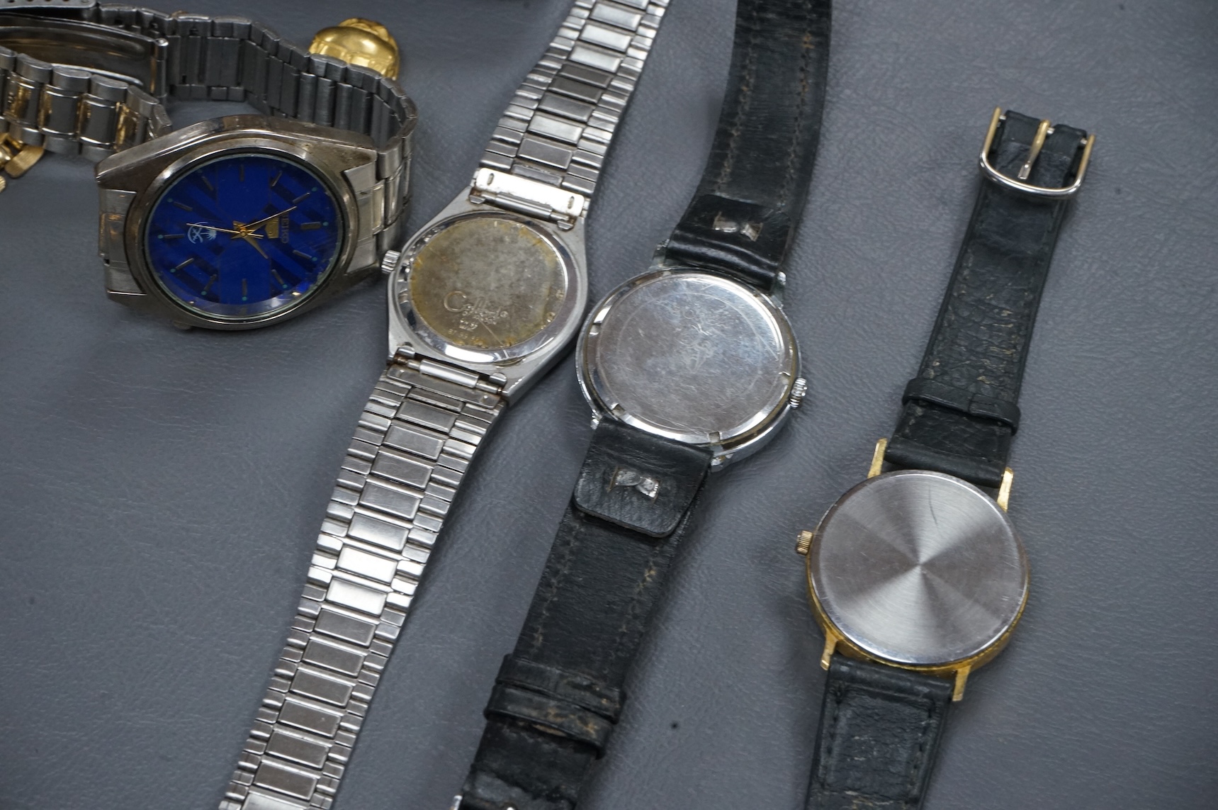 A quantity of assorted costume jewellery and other items including wrist watches, watch movements and a silver vesta case.